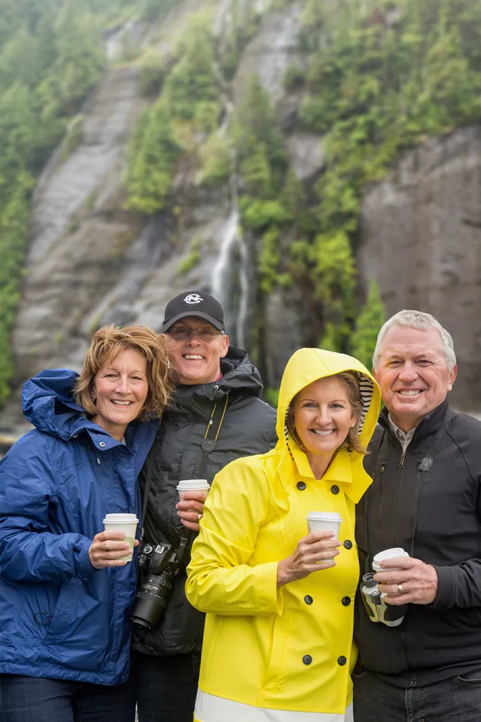 Group of people standing together holding cups of hot chocolate