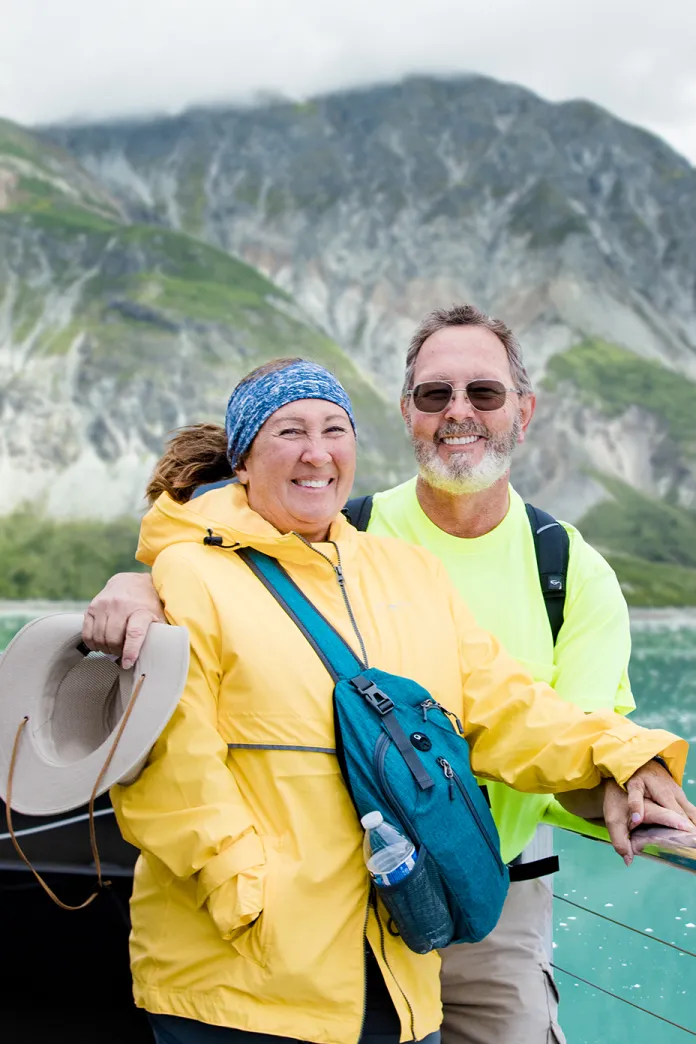 A couple standing together on the ship deck in Alaska